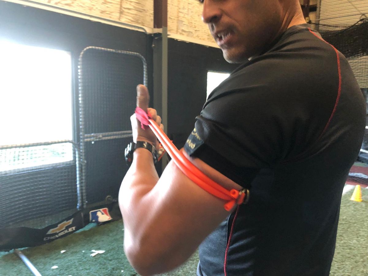 Coach wearing the Power Punch strap in the cage